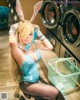 A woman in a bunny costume posing in front of a washing machine.