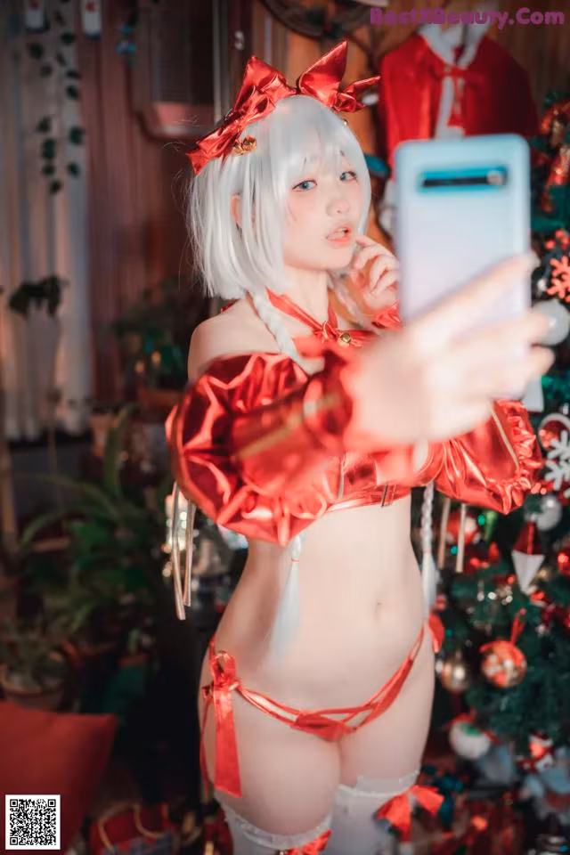 A woman in a red and white outfit taking a selfie.