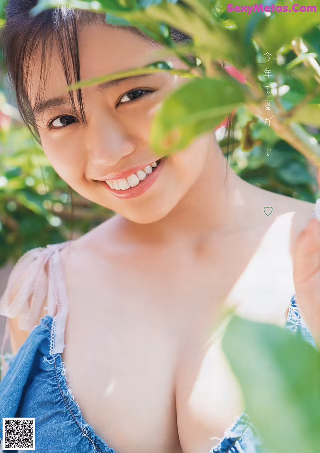 A young woman in a blue dress posing for a picture.