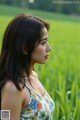 A woman standing in a field of green grass.